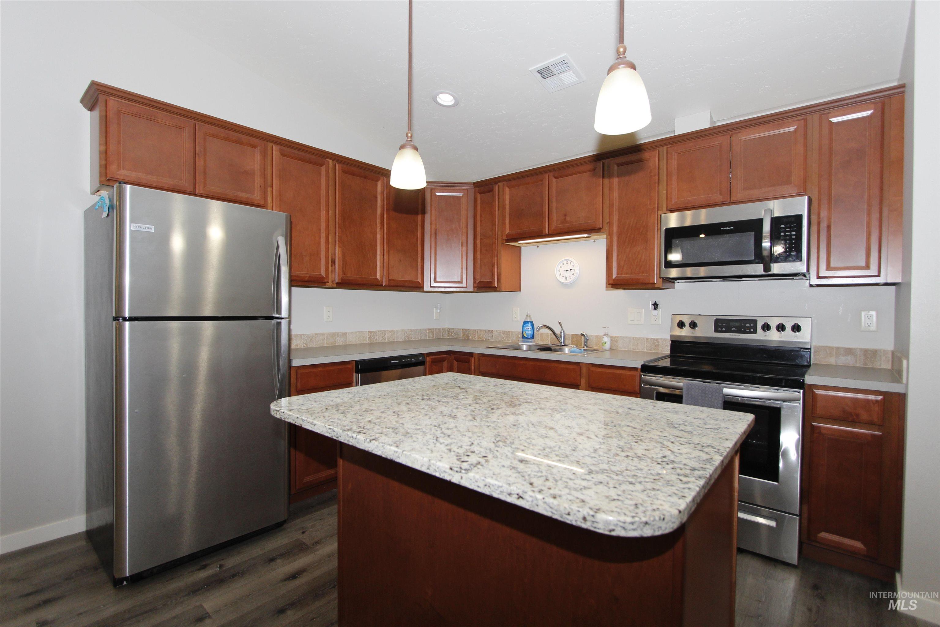 3434 5th Street, Unit B Lewiston, ID 83501 - Photo 2 of 14 Kitchen with stainless steel appliances, a center island, decorative light fixtures, dark wood finished floors, and recessed lighting