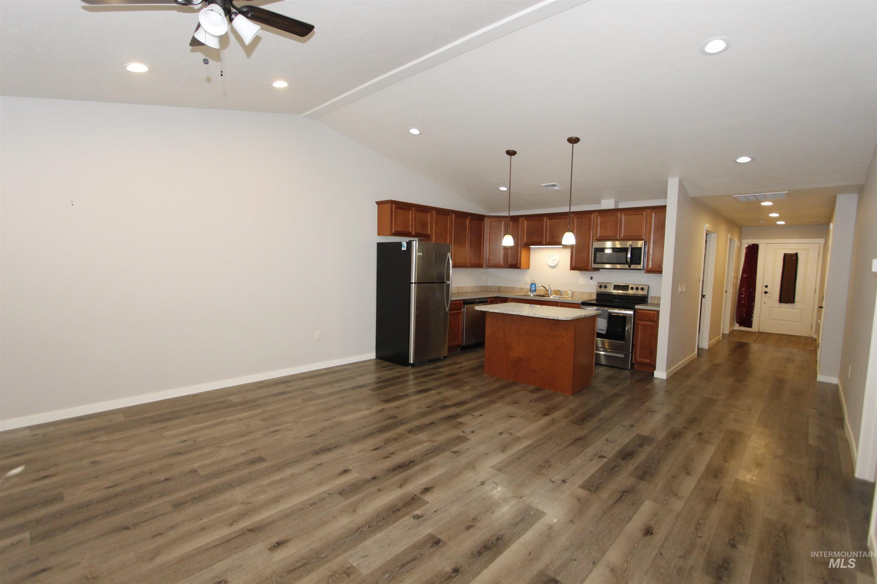 3434 5th Street, Unit B Lewiston, ID 83501 - Photo 14 of 14 Kitchen featuring open floor plan, stainless steel appliances, a center island, light countertops, and pendant lighting