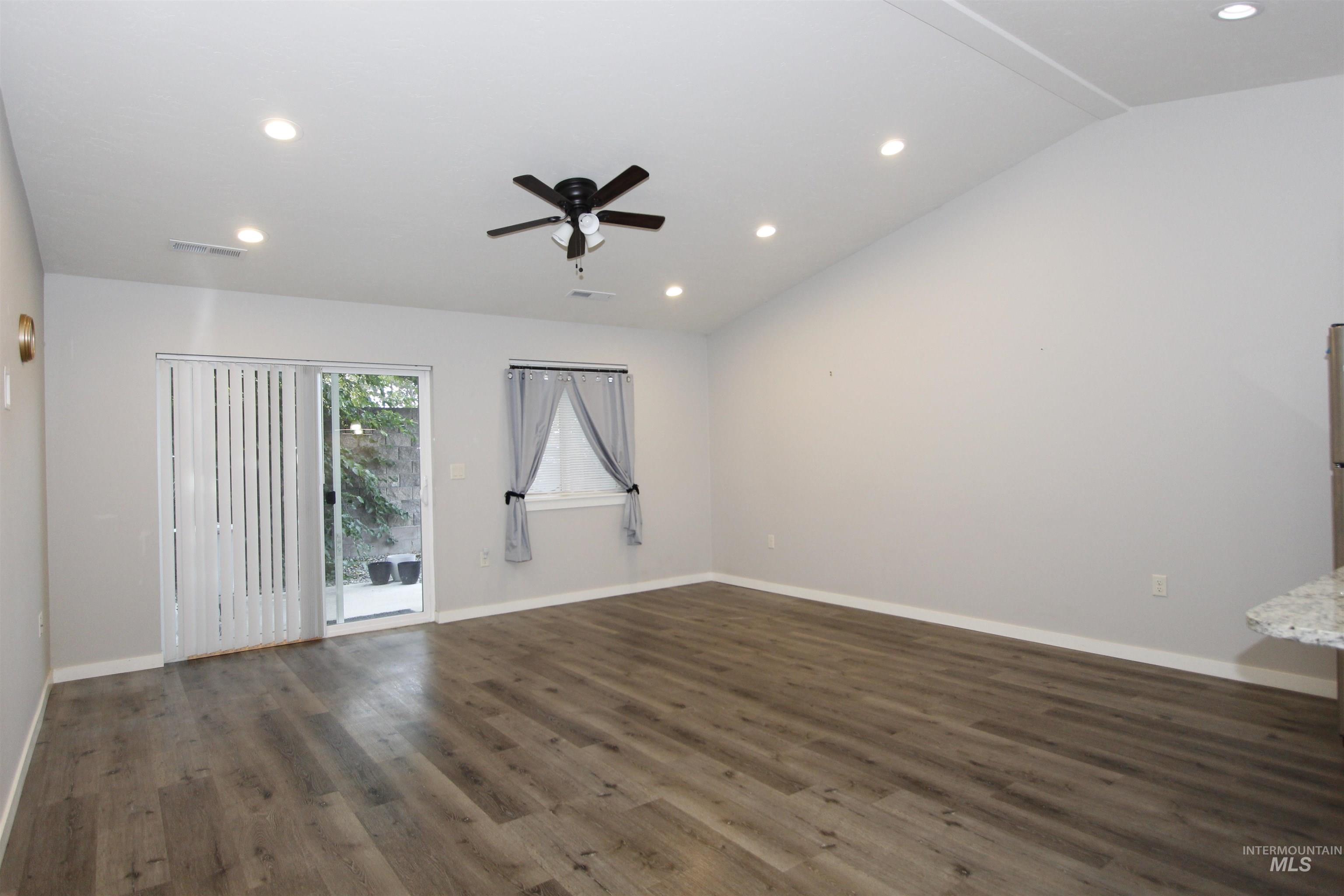 3434 5th Street, Unit B Lewiston, ID 83501 - Photo 4 of 14 Unfurnished room featuring dark wood-style flooring, recessed lighting, ceiling fan, and lofted ceiling