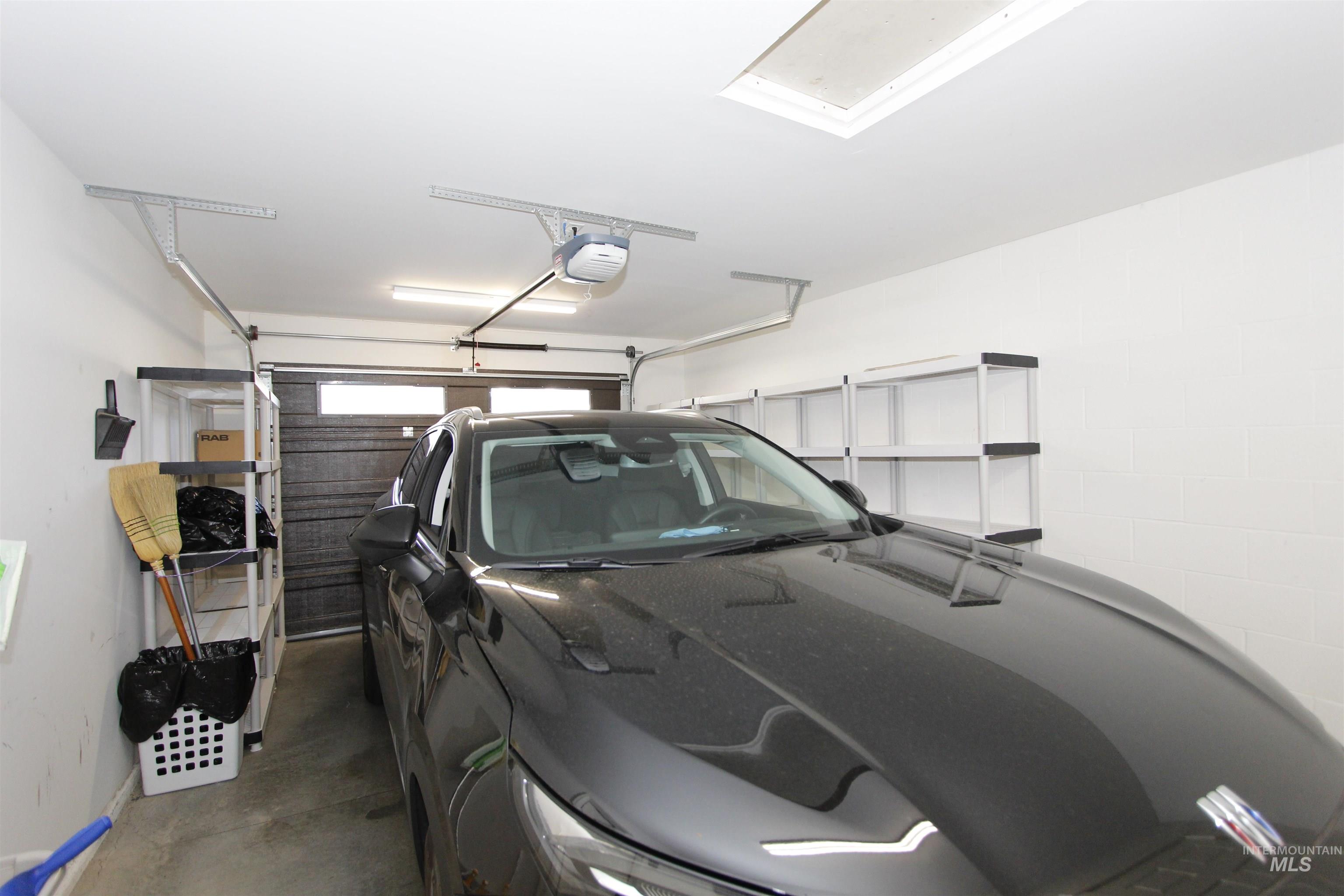3434 5th Street, Unit B Lewiston, ID 83501 - Photo 9 of 14 Garage with a garage door opener and baseboards