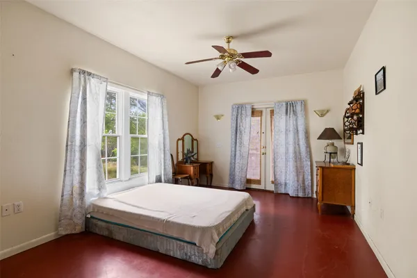 a bedroom with a large bed and a chandelier