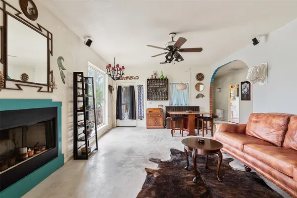 a living room with furniture a fireplace and a flat screen tv