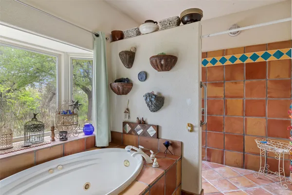 a bathroom with a tub and a window