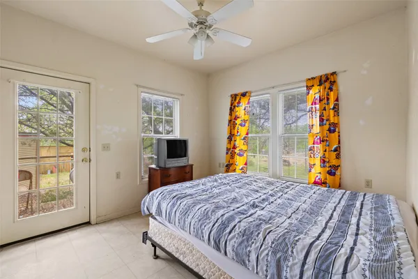 a bedroom with a large bed and a chandelier
