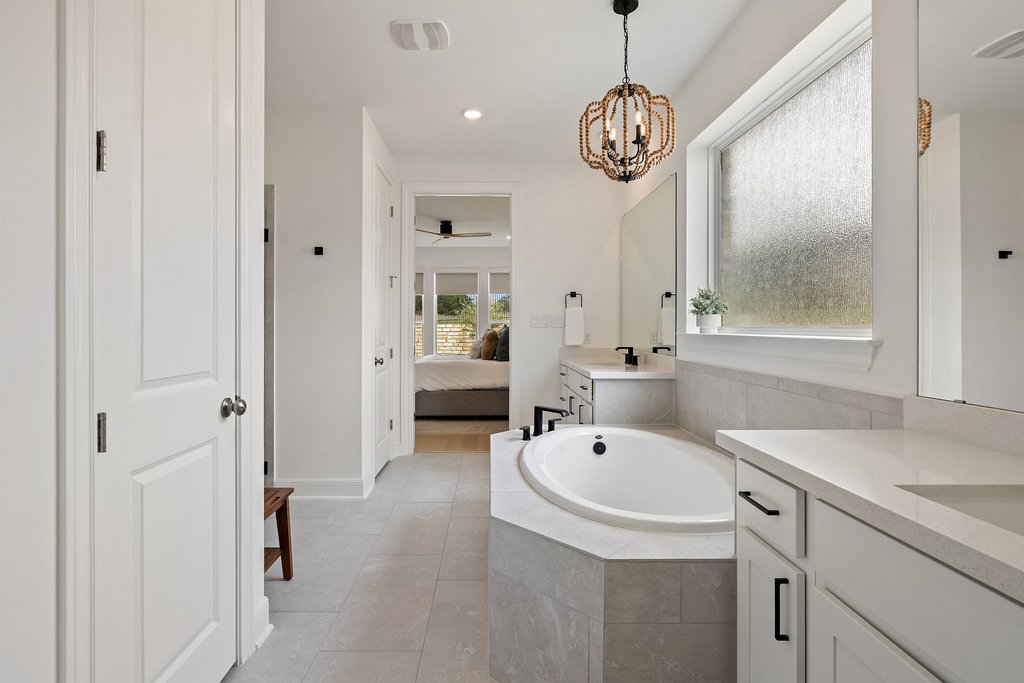 365 Pear Tree Lane Austin, TX 78737 - Photo 24 of 39 a bathroom with a sink a large mirror and a shower