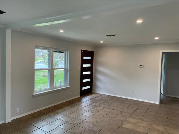 an empty room with windows and closet