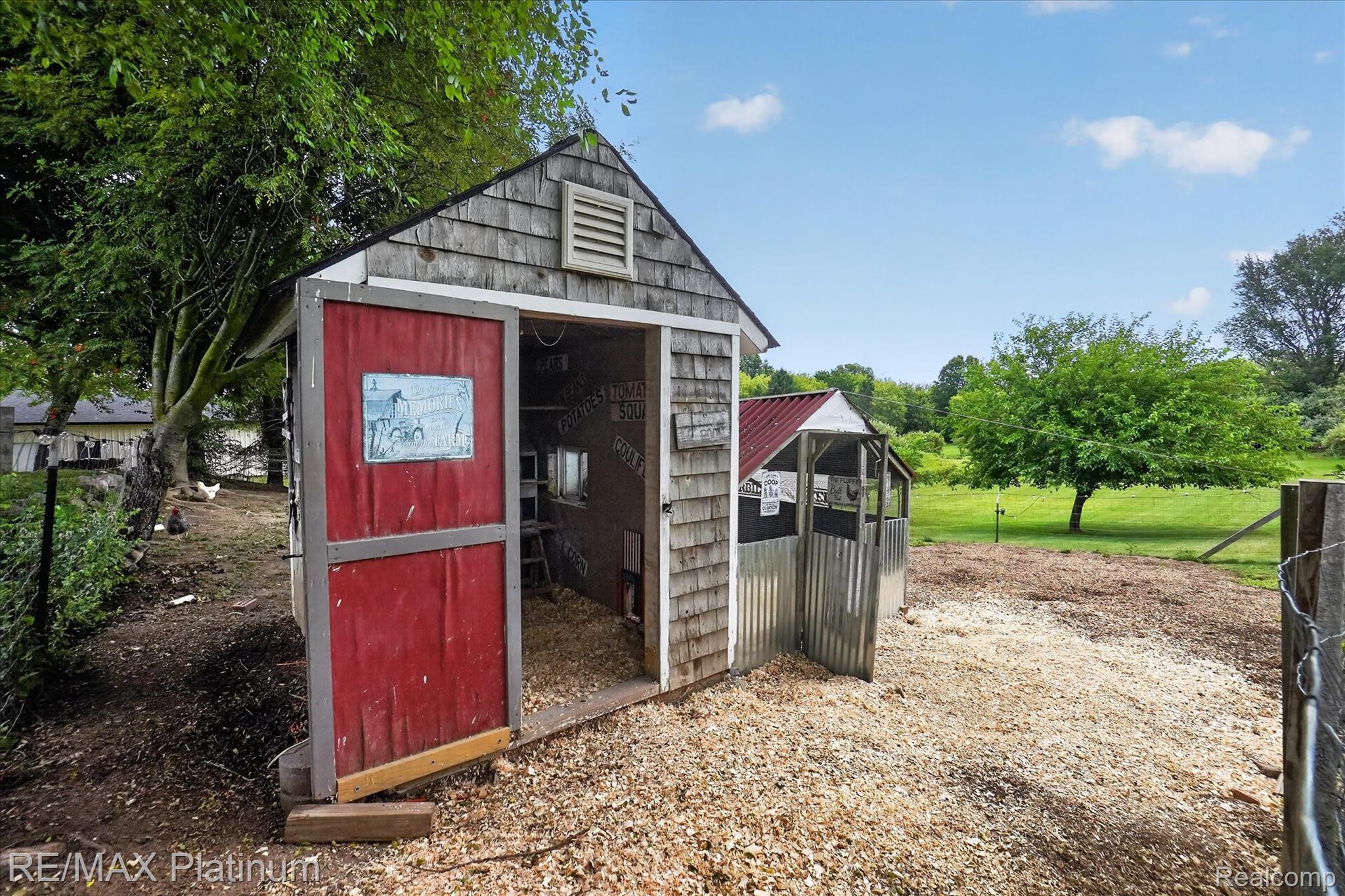 4457 Bradley Road Gregory, MI 48137 - Photo 50 of 79 Wood-shingle outbuilding with red-painted doors and a louvered gable vent