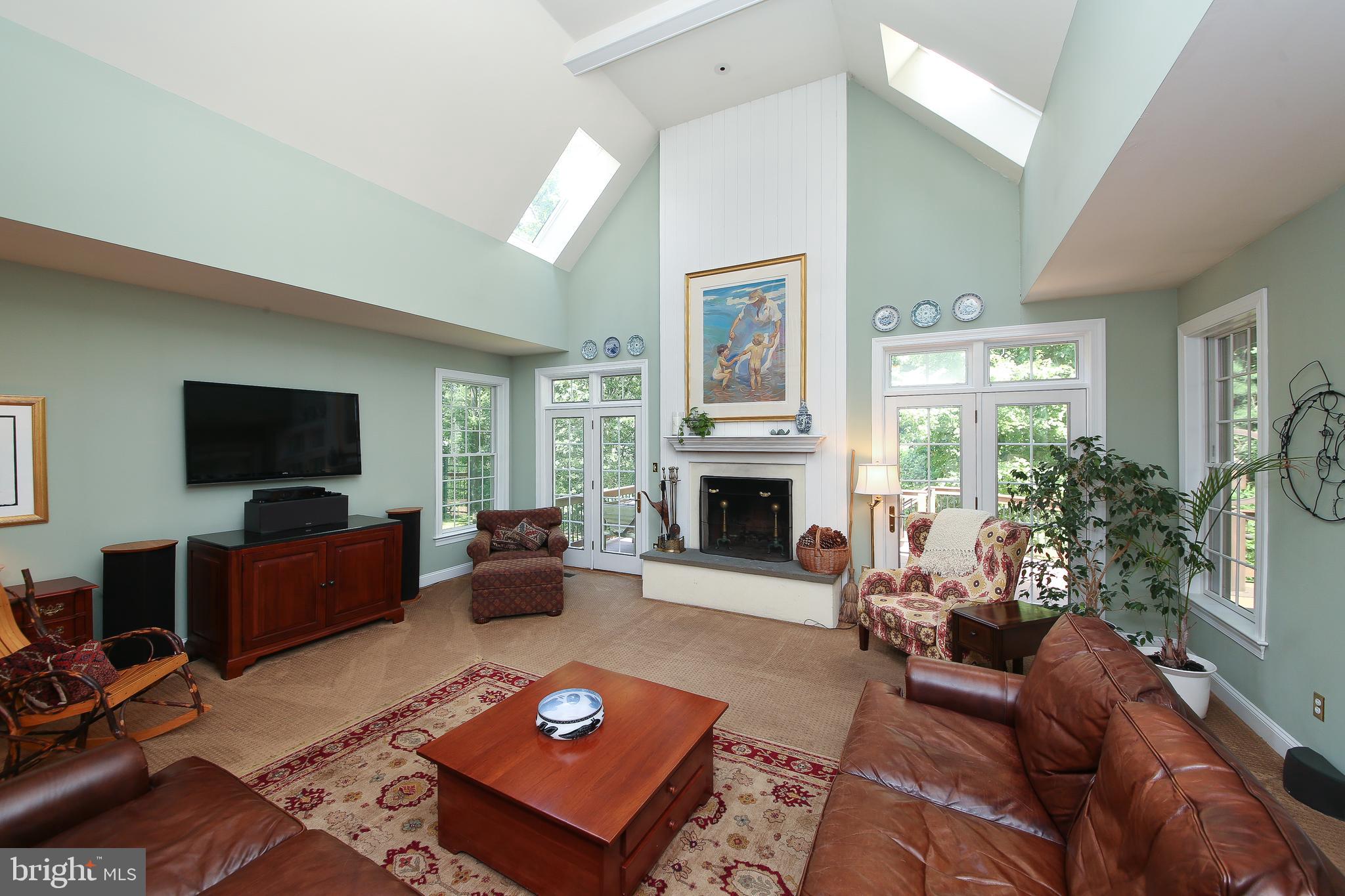 4 Paul Road Wayne, PA 19087 - Photo 11 of 46 a living room with furniture a fireplace and a flat screen tv