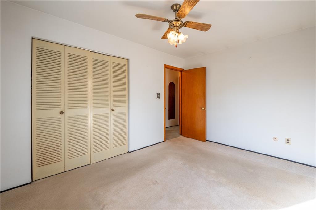 222 Ridgefield Drive Greensburg, PA 15601 - Photo 17 of 28 an empty room with a chandelier fan and closet
