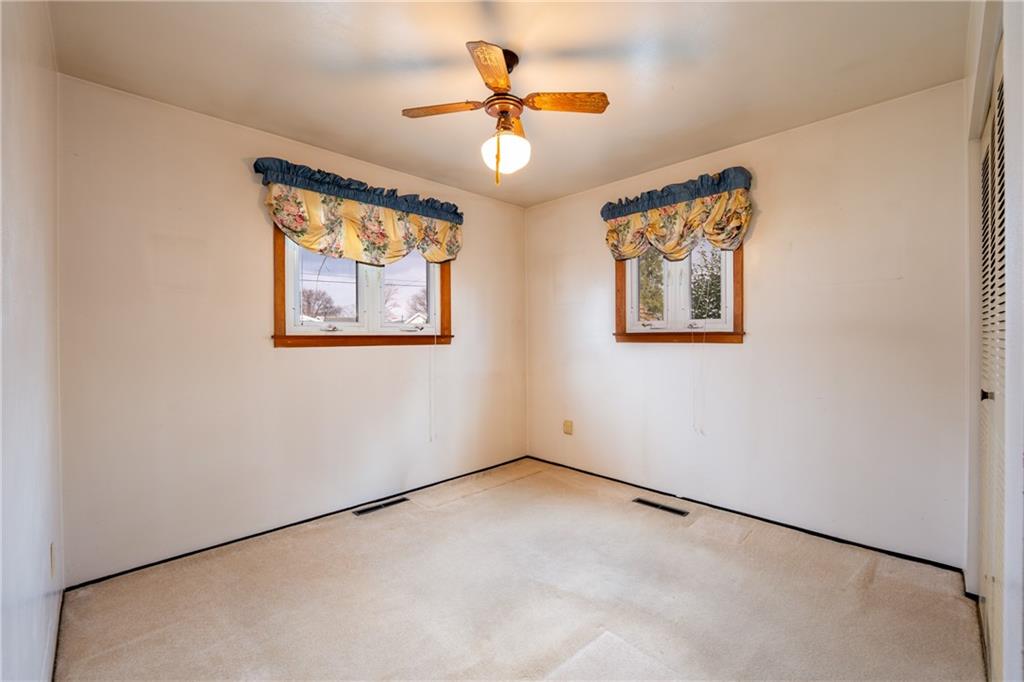 222 Ridgefield Drive Greensburg, PA 15601 - Photo 19 of 28 an empty room with a window and a ceiling fan