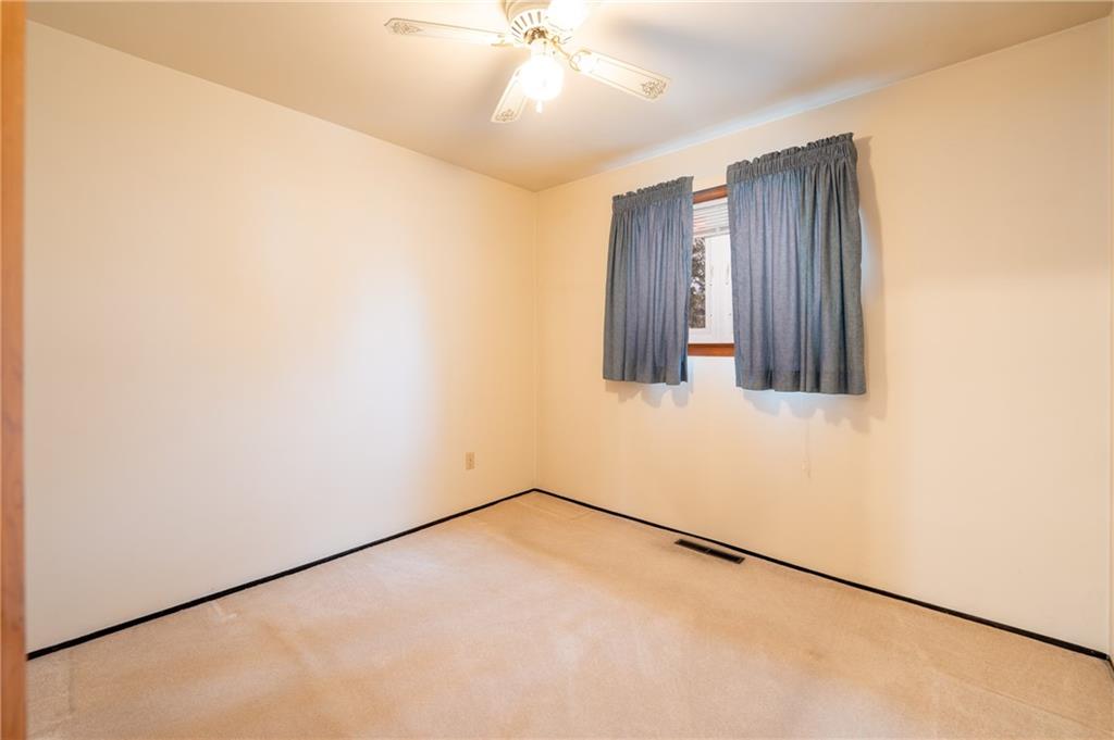 222 Ridgefield Drive Greensburg, PA 15601 - Photo 21 of 28 an empty room with a chandelier fan and windows