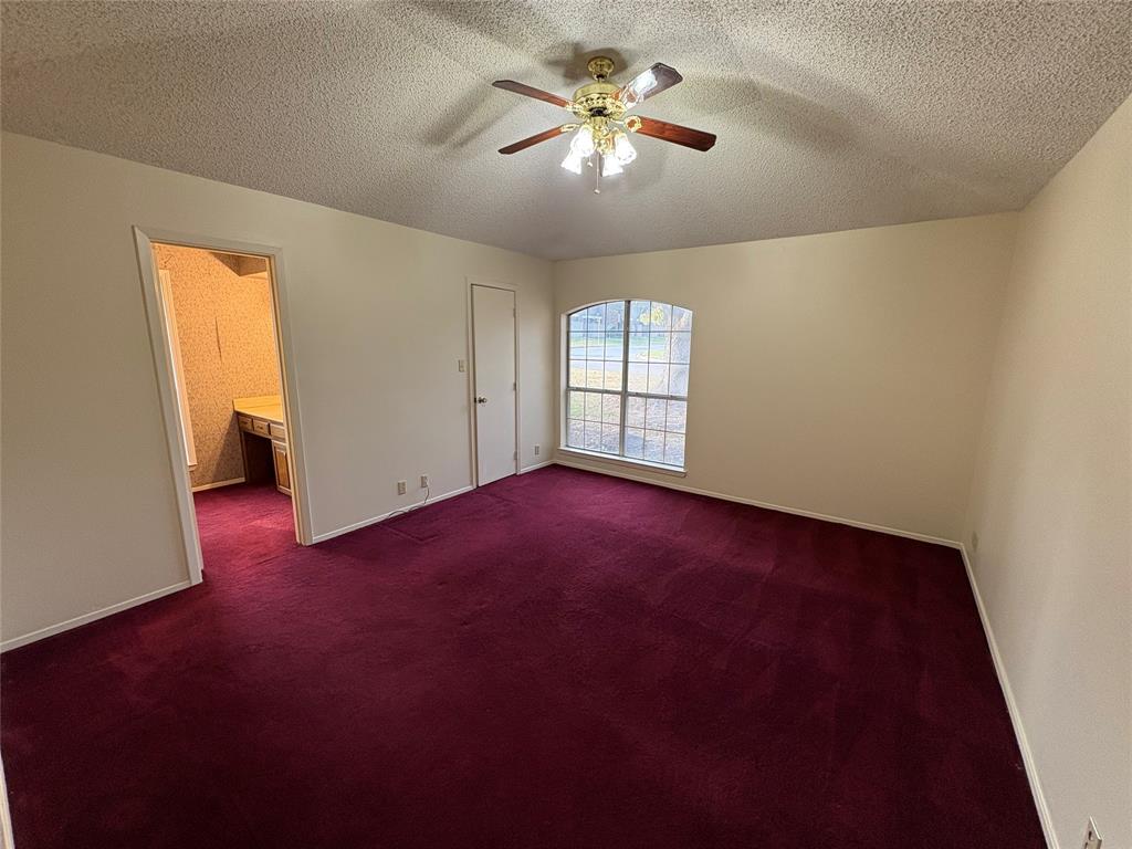 1838 West Taylor Street Sherman, TX 75092 - Photo 6 of 33 an empty room with windows and chandelier fan