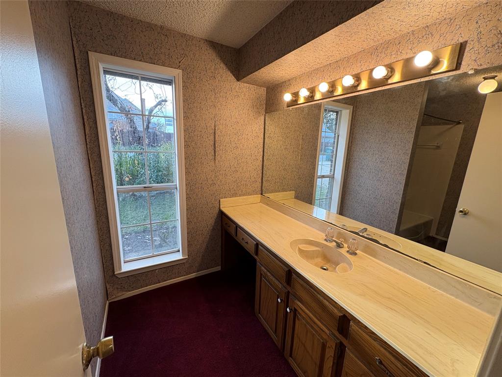1838 West Taylor Street Sherman, TX 75092 - Photo 8 of 33 a bathroom with a double vanity sink and a mirror