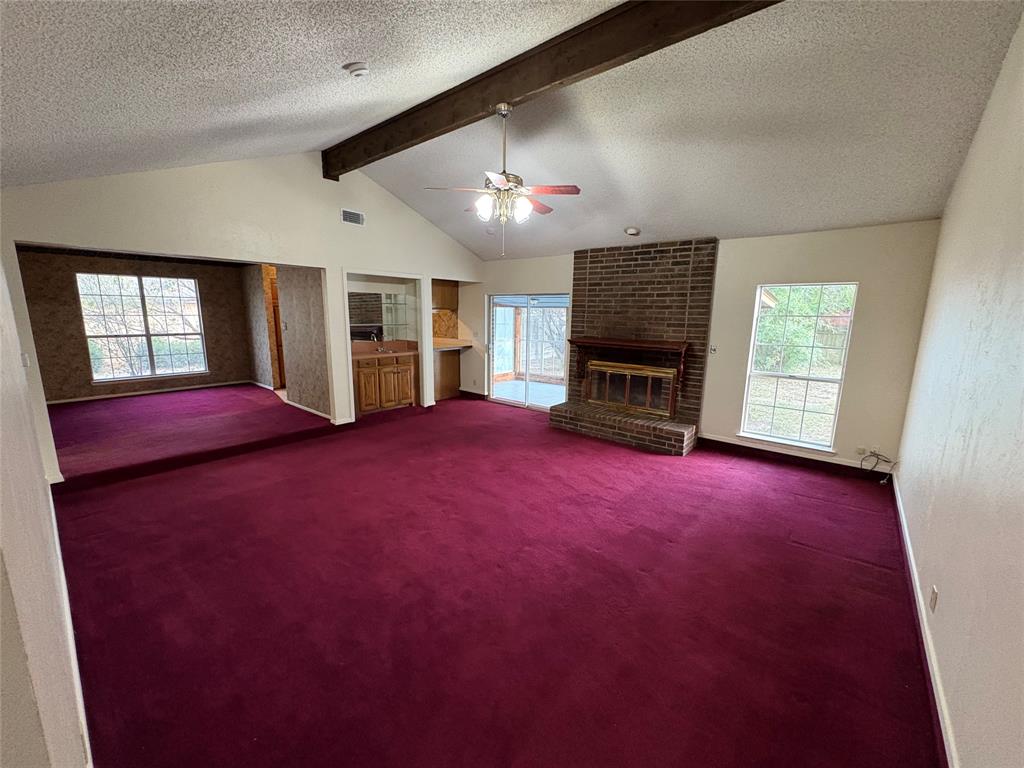 1838 West Taylor Street Sherman, TX 75092 - Photo 10 of 33 an empty room with windows and fireplace