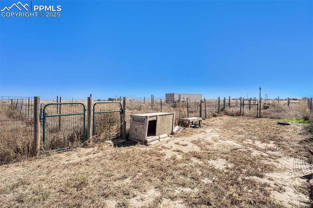 6855 Lauppe Road Yoder, CO 80864 - Photo 24 of 27 a view of a dry yard with wooden fence