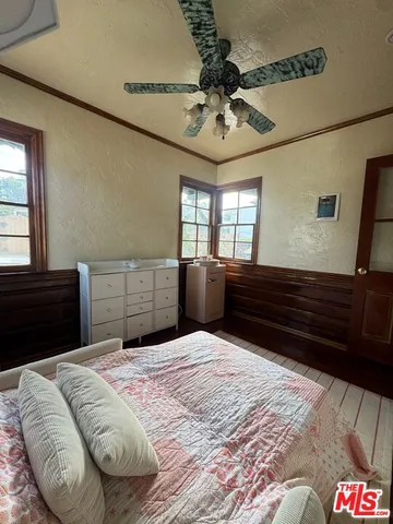 a bedroom with a large bed and a dresser