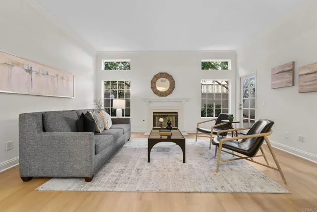 a living room with furniture kitchen view and a fireplace