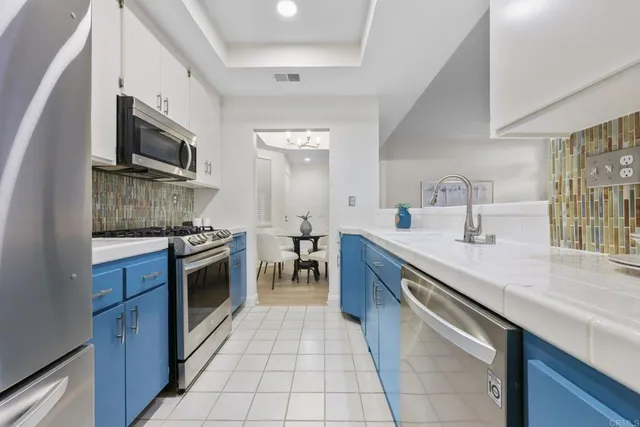 a kitchen with stainless steel appliances granite countertop a sink and a stove top oven