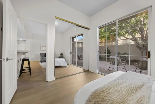 a bedroom with a bed and a large window