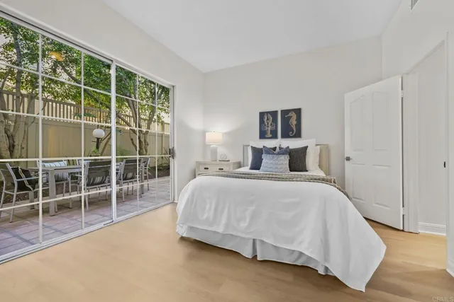 a spacious bedroom with a bed and a window