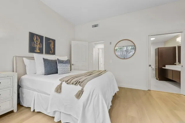 a bed room with a bed mirror and a window