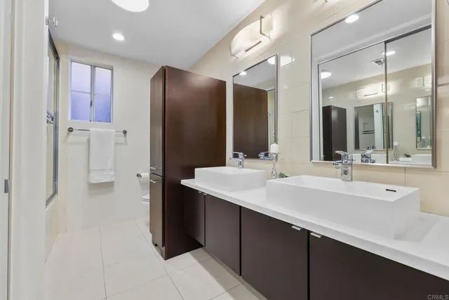 a bathroom with a double vanity sink mirror and double