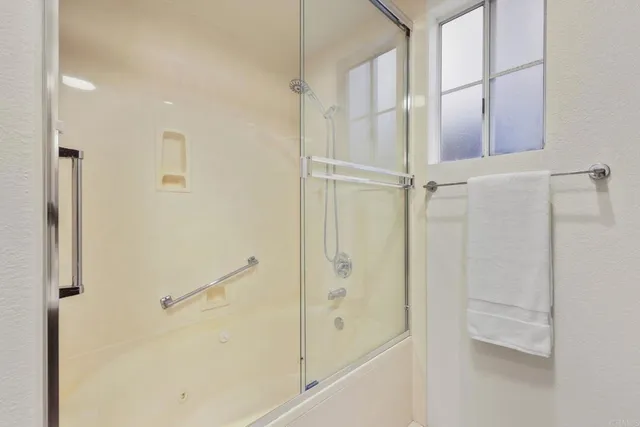 a bathroom with a glass shower door