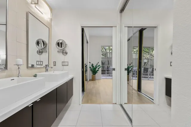 a spacious bathroom with a double vanity sink and a mirror