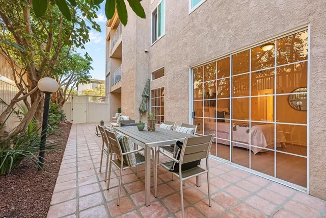 a view of a dinning table and chairs in the patio