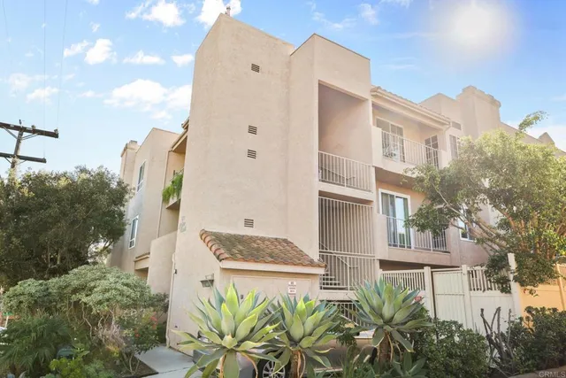 a aerial view of a house with a yard and potted plants