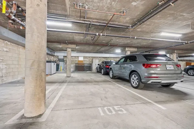 a view of parking garage with cars parked