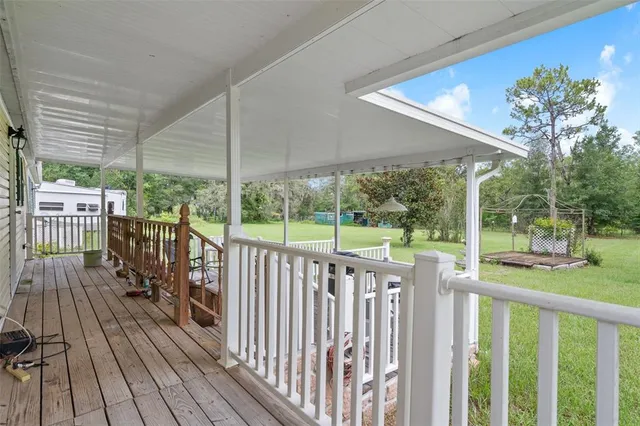 a living room with furniture a flat screen tv and a dining table