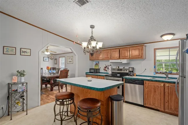 a room with furniture a chandelier and pool table