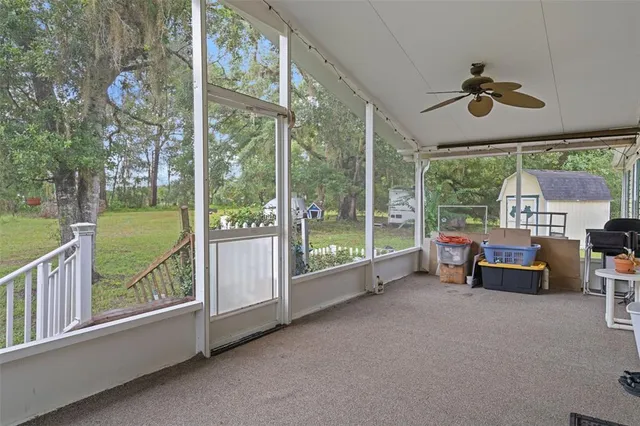 a view of a deck with wooden floor and fence with a floor to ceiling window