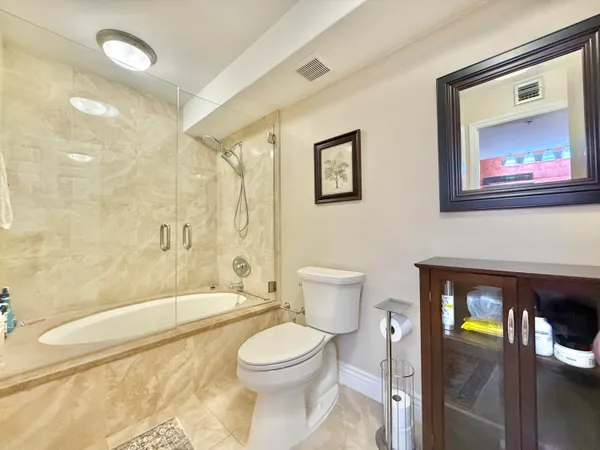 a view of a dining room and kitchen with granite countertop a stove a sink dishwasher a dining table and chairs with wooden floor