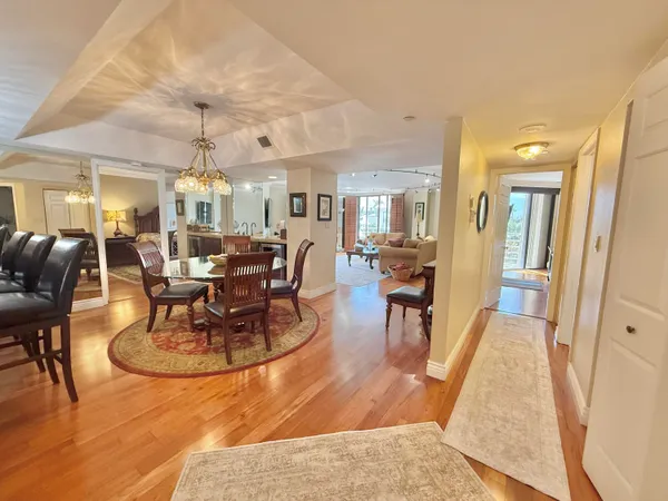 a living room with lots of furniture and view of dining room
