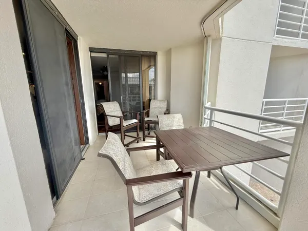 a view of a balcony with a table and chairs