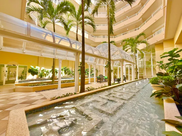 a vase of flowers sitting on a floor in front of a door