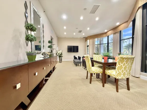 a room with pool table and a large window