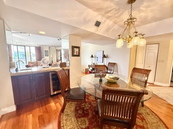 a living room with furniture a chandelier and a dining table
