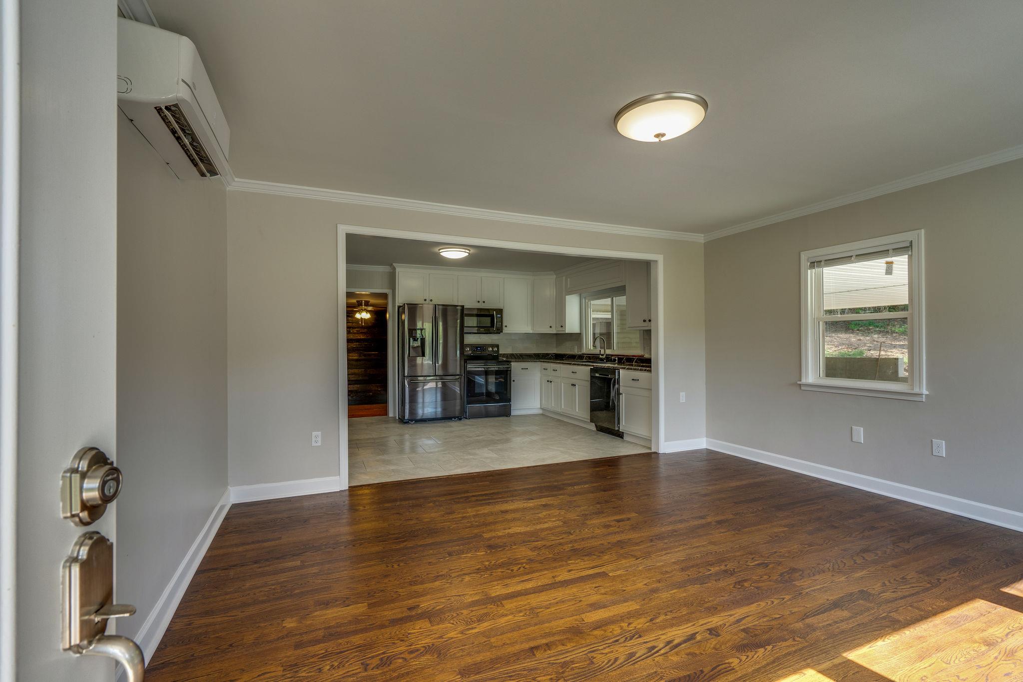 2720 Toll Gate Road Petersburg, TN 37144 - Photo 7 of 22 Open den looking into updated kitchen with refinished original hardwood floors!