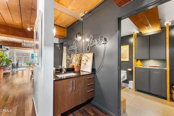 a view of a kitchen from a dining room with furniture