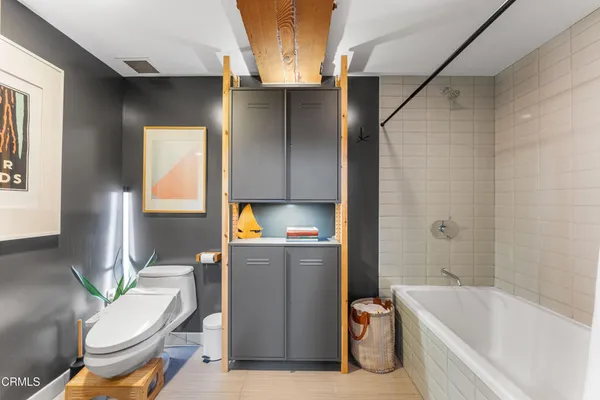a bathroom with a toilet and a bathtub