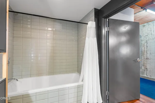 a bathroom with a bathtub and shower