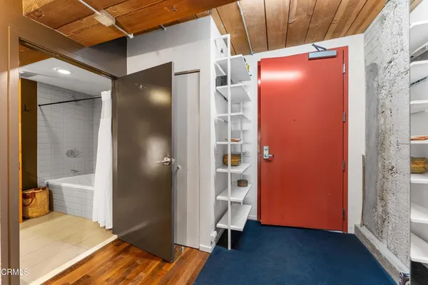 a view of a room with wooden floor and bathroom