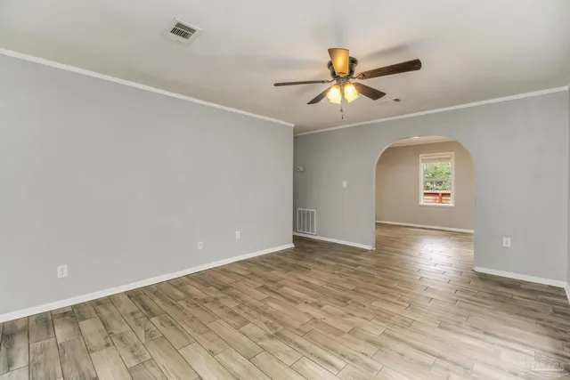 wooden floor in an empty room with a window