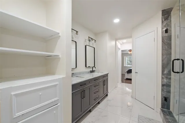 a spacious bathroom with a granite countertop sink mirror and double