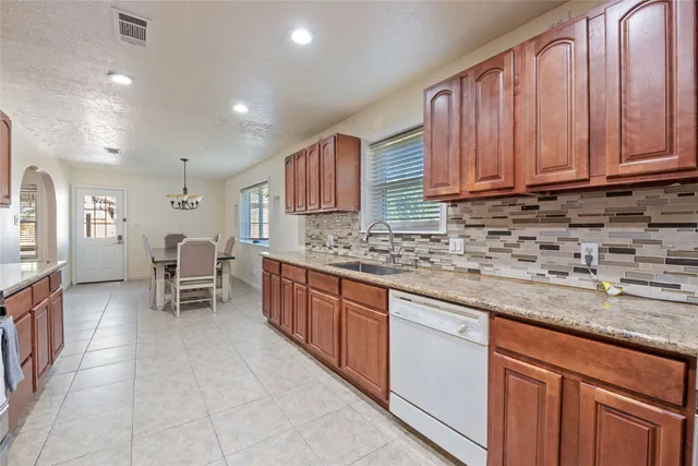 a kitchen with stainless steel appliances granite countertop a sink and cabinets