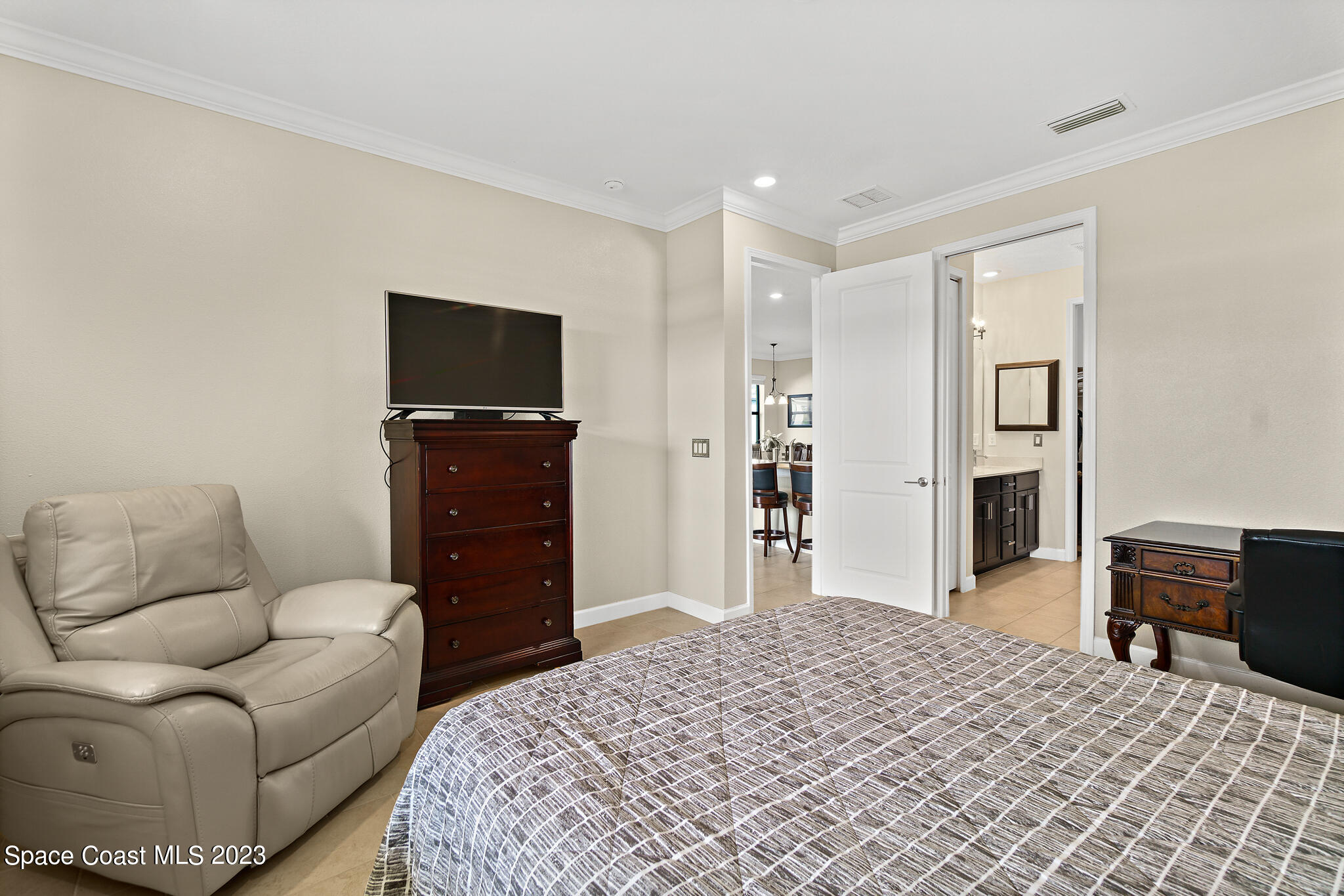 9753 Alister Drive Melbourne, FL 32940 - Photo 12 of 42 a bedroom with a bed and furniture