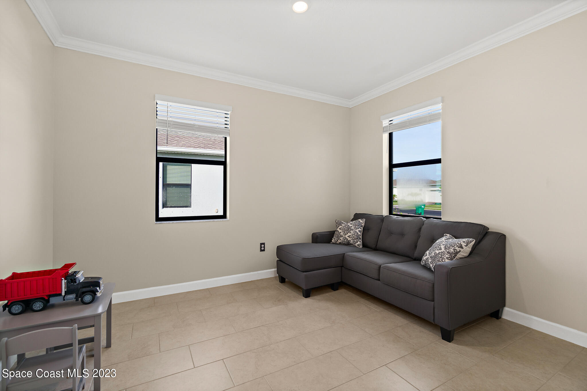 9753 Alister Drive Melbourne, FL 32940 - Photo 14 of 42 a living room with furniture and a window